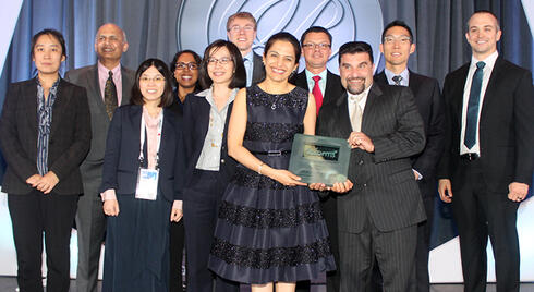 Winners of an INFORMS Prize award, the BNSF team standing together and smiling at an Edelman Gala.