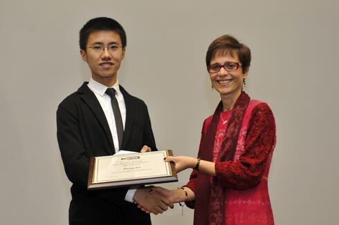Kuang Xu从INFORMS总裁Rina Schneur那里获得奖项